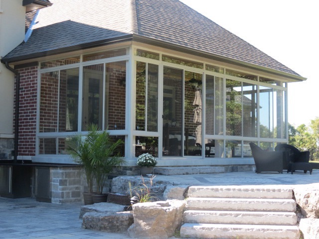 Leaking sunroom roof repair in Toronto — Alumwave Glazing technician inspecting glass panels